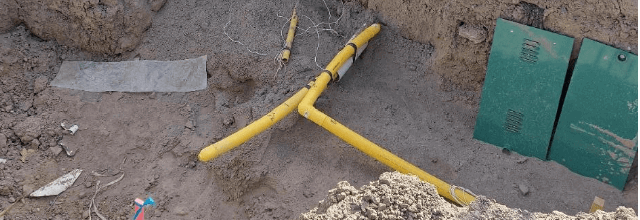 Image of technicians fixing uncovered buried gas lines.